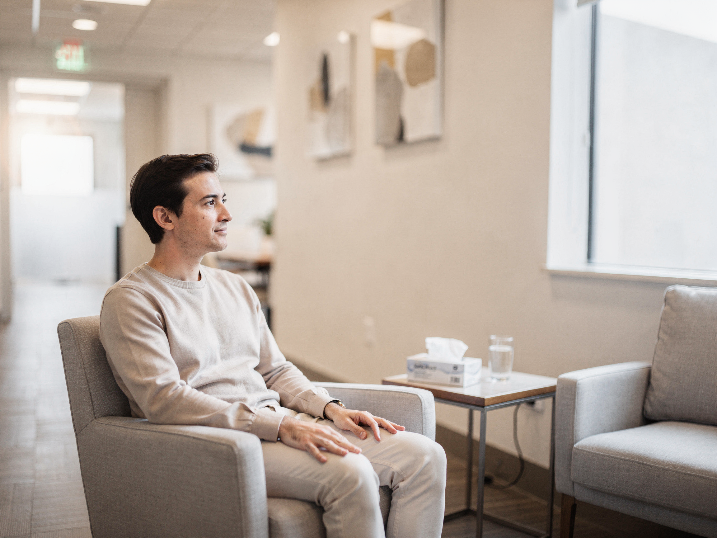 Patient sitting in a modern clinic waiting room at Texas Sinus and Snoring